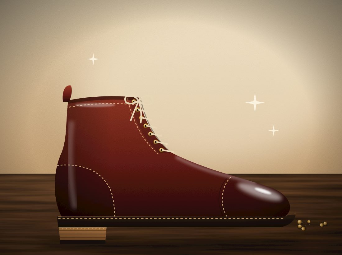 The same boot after repair: polished oxblood leather, new stitched sole and a fresh stacked heel