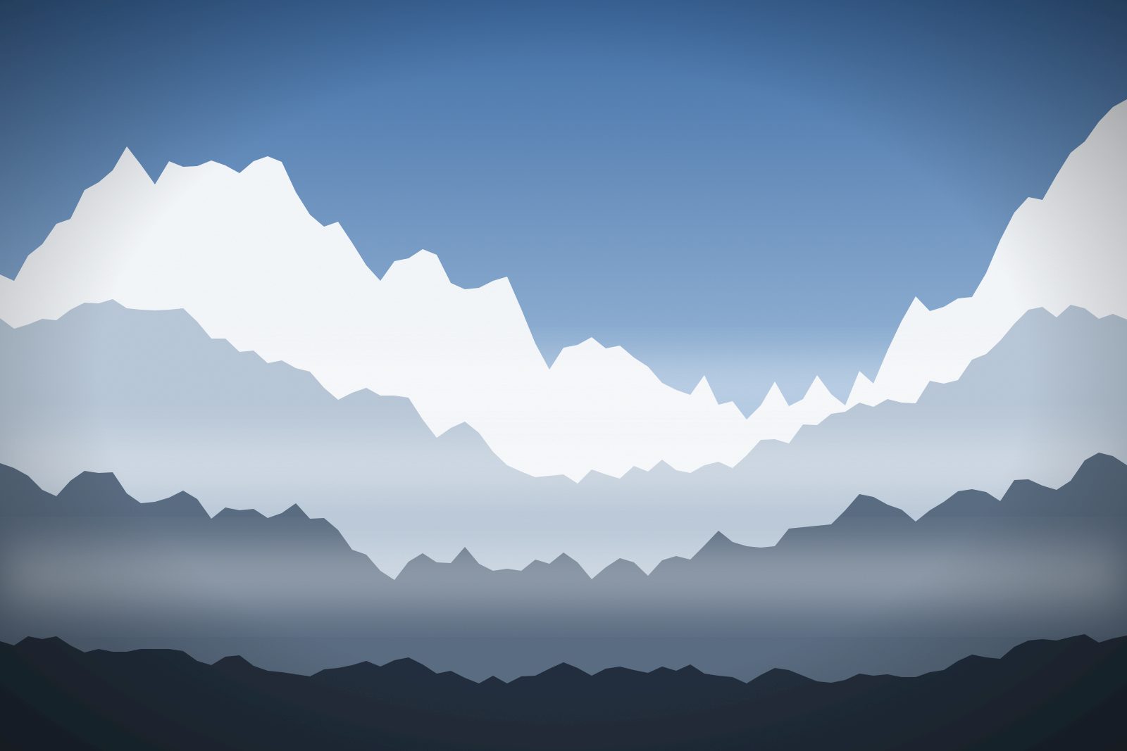 Snow-covered peaks above a misty valley